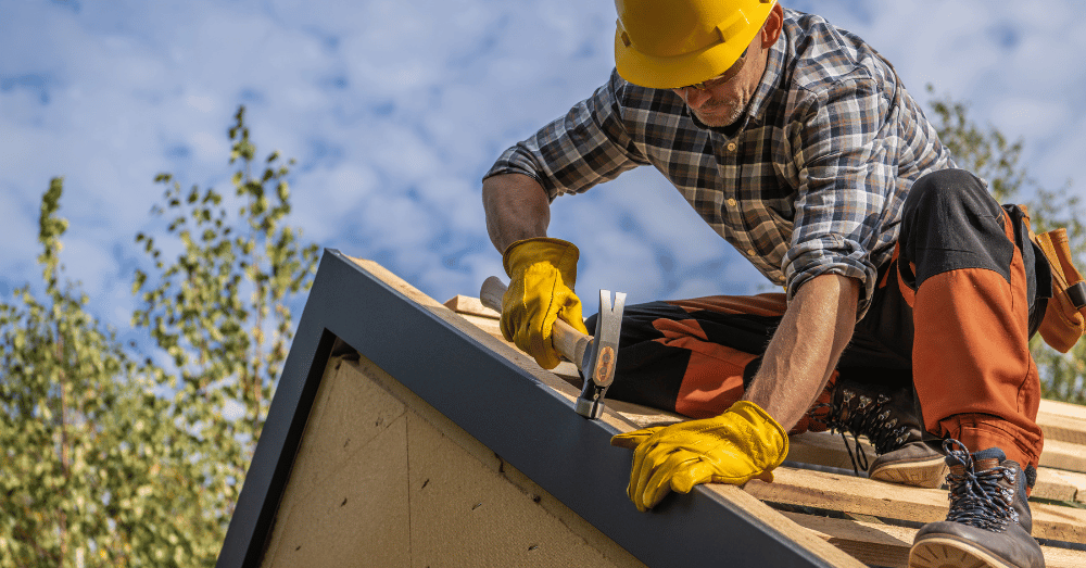 5 things a professional contractor would never do - contractor on a roof wearing yellow hard hat and yellow gloves